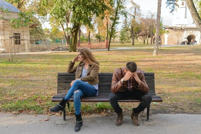 couple on a bench struggling to communicate
