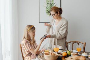 Mother and daughter talking at the dinner table