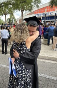 Mother and son embracing at college graduation