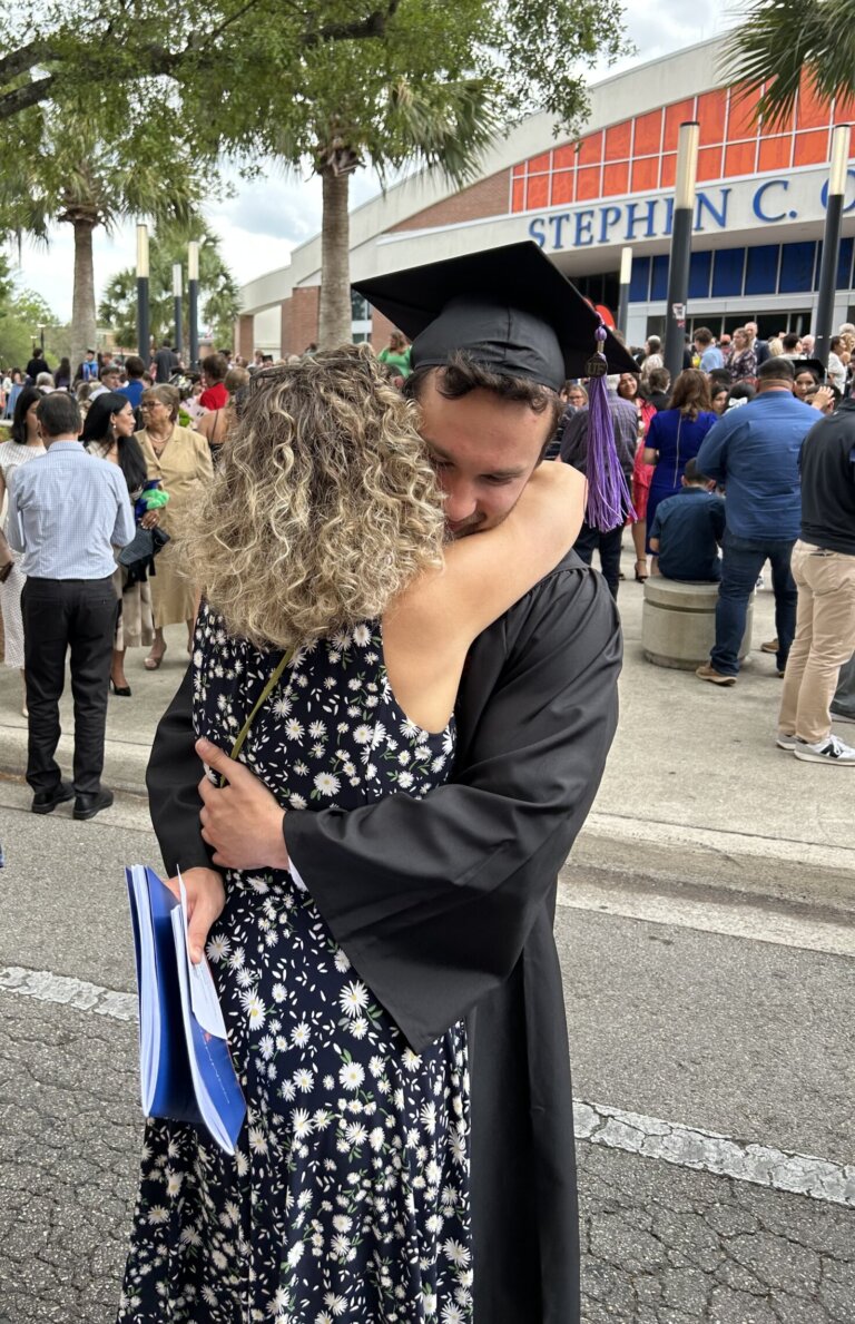 Mother and son embracing at college graduation